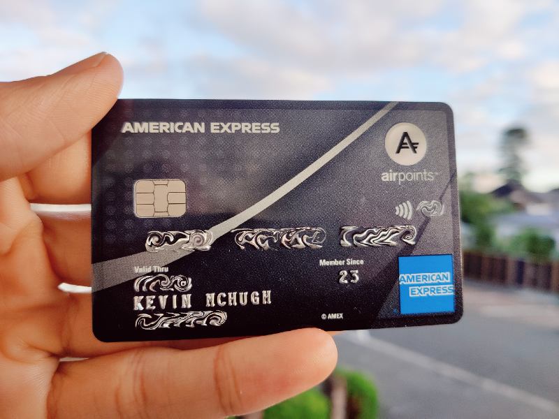 The author's hand holding an American Express Airpoints Platinum credit card.